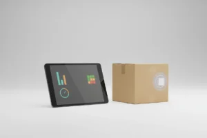 Tablet with a text-free inventory dashboard beside an RFID-tagged box on a soft neutral background.
