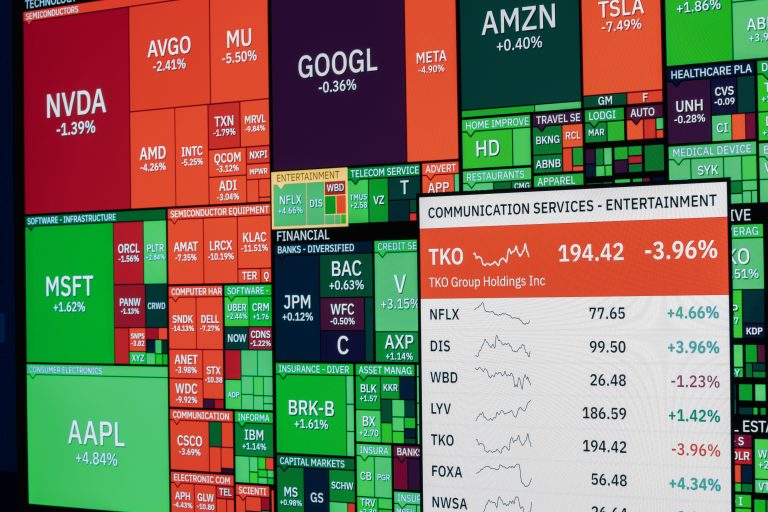 professional analyzing investment data on multiple screens