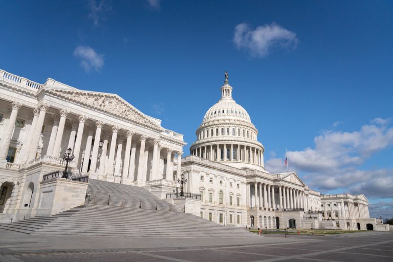 The United States Capitol beneath a blue sky