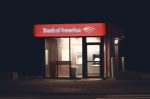 Illuminated Bank of America ATM structure against a dark nighttime backdrop in Boston