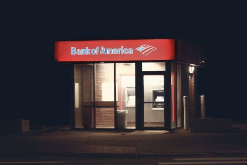 Illuminated Bank of America ATM structure against a dark nighttime backdrop in Boston