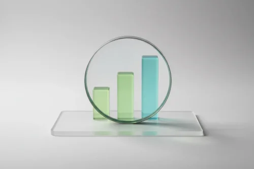 Glass magnifying glass enlarging a clean green bar chart on a frosted acrylic panel, symbolizing transparency in impact investing.