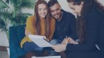 A couple reviews paperwork with a financial adviser
