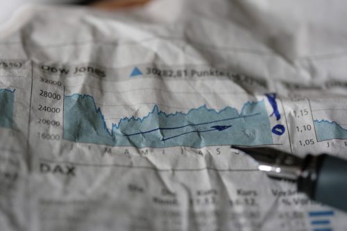 stacks of financial documents and data charts representing Q2 earnings season